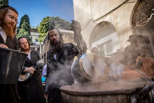 Ultra-Orthodox Jewish people boil cooking utensils in water to remove the remains of leaven in preparation for the upcoming Jewish holiday of Passover, in Haifa, Israel on April 3, 2023. (Photo by Shir Torem/Reuters)
