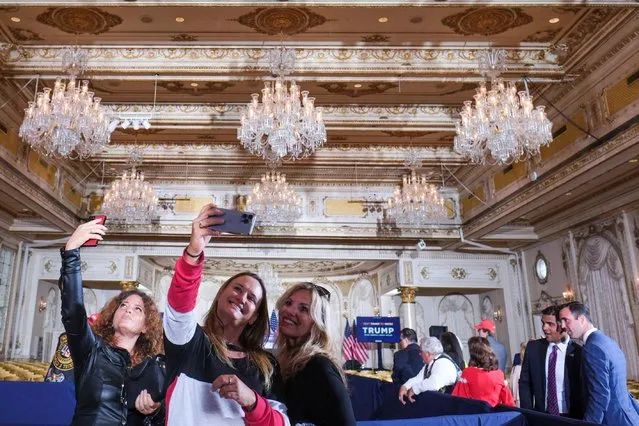 Women take selfies at Mar-a-Lago resort, on the day of former U.S. President Donald Trump's court appearance after his indictment by a Manhattan grand jury following a probe into hush money paid to p*rn star Stormy Daniels, in Palm Beach, Florida, U.S., April 4, 2023. (Photo by Ricardo Arduengo/Reuters)