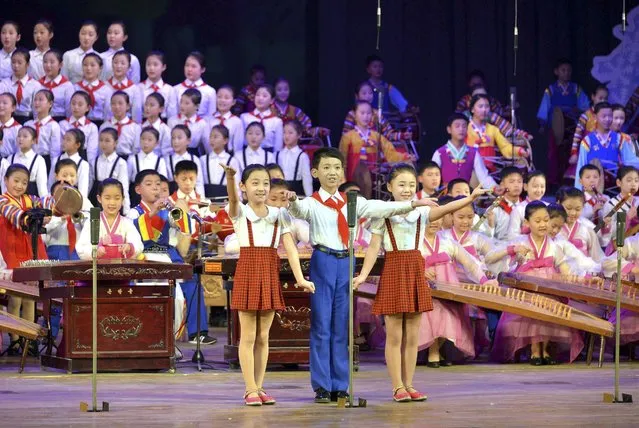 Schoolchildren's New Year performance “We Are the Happiest in the World” is given at the Central Youth Hall on the occasion of the New Year, December 31, in this photo released by North Korea's Korean Central News Agency (KCNA) in Pyongyang December 31, 2014. (Photo by Reuters/KCNA)