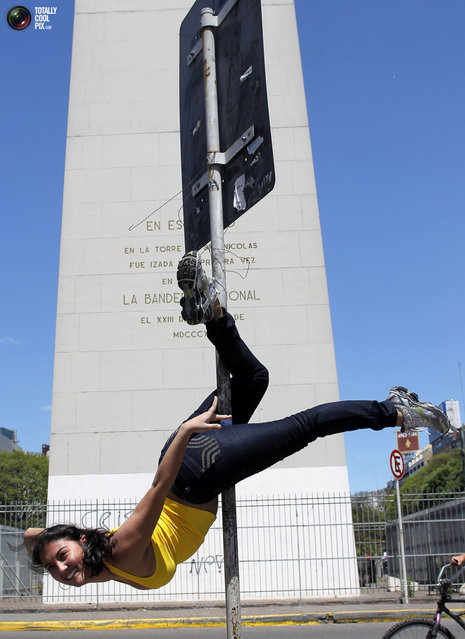 A woman performs a pole dancing routine to promote the Miss Pole Dancing Southamerica 2010 competition in Buenos Aires November 5, 2010. (Photo by Enrique Marcarian/Reuters)