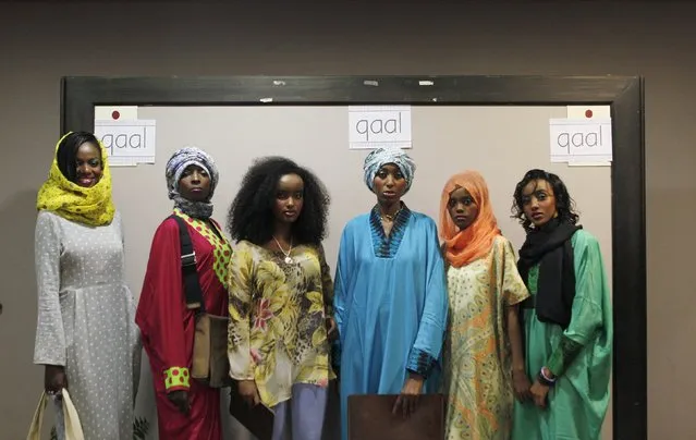 Models pose with creations by Somalia-born designer Nimco Adam during the Somali Heritage Week at the National Museum in Nairobi, November 21, 2015. Adam says that her work is inspired by resilient women at war in Africa. (Photo by Noor Khamis/Reuters)