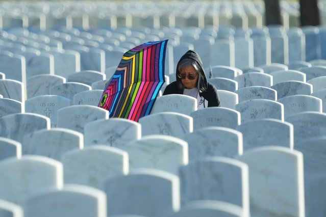 Norma Like visits the gravesite of her husband before a Veteran's Day observance at the Fort Sam Houston National Cemetery in San Antonio, Tuesday, November 11, 2025. (Photo by Eric Gay/AP Photo)
