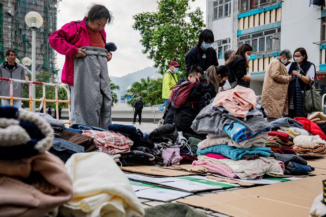 Displaced residents from an apartment fire in Tai Po district collect donated clothing in Hong Kong, China, 27 November 2025. The fire, which started on 26 November, has killed at least 44 people, and left 279 missing. (Photo by Leung Man Hei/EPA)