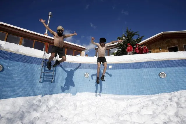 Residents play with snow inside a swimming pool in Jizeen, southern Lebanon January 11, 2015. (Photo by Ali Hashisho/Reuters)