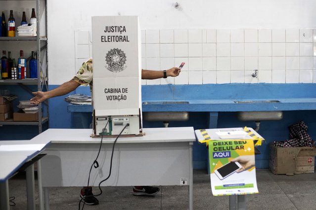 A man votes in municipal elections in the Rocinha community of Rio de Janeiro, Sunday, October 6, 2024. (Photo by Bruna Prado/AP Photo)