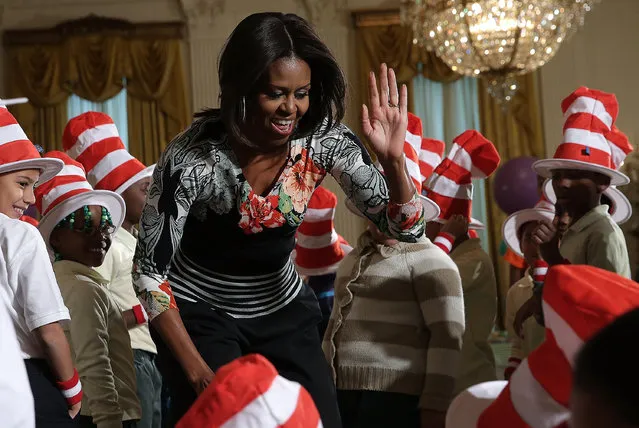 U.S. first lady Michelle Obama greets local school children after reading a Dr. Seuss book to them in the East Room of the White House on January 21, 2015 in Washington, DC. As part of the “Let's Read, Let's Move” initiative, the first lady read “Oh The Things You Can Do That Are Good For You” and danced and exercised with the children. (Photo by Win McNamee/Getty Images)