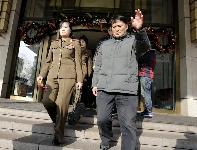 A man gestures as he escorts members of the Moranbong Band from North Korea to leave a hotel in central Beijing, China, December 11, 2015. (Photo by Reuters/Stringer)