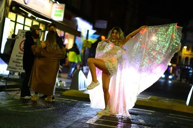 People party on a street as pubs shut for the night due to tier 3 restrictions in Soho, as the spread of the coronavirus disease (COVID-19) continues in London, Britain, December 15, 2020. (Photo by Aaron Chown/The Sun)