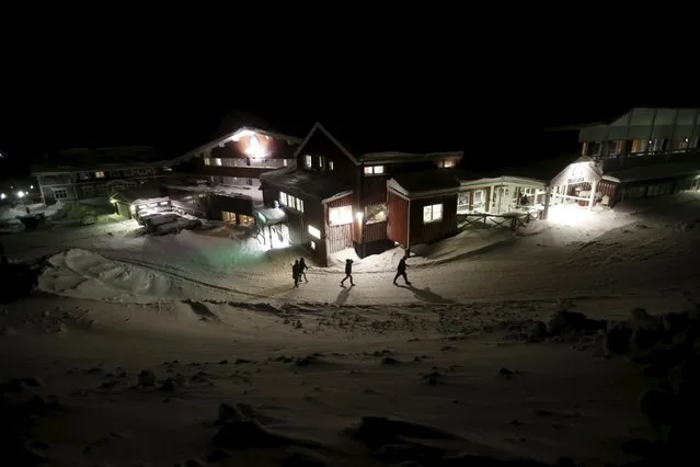 Refugees walk to their camp at a hotel touted as the world's most northerly ski resort in Riksgransen, Sweden, December 15, 2015. (Photo by Ints Kalnins/Reuters)