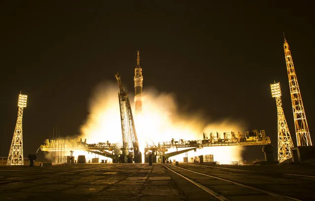 In this one second exposure photograph provided by NASA, a Soyuz MS-03 spacecraft launches for the International Space Station from the Baikonur Cosmodrome with Expedition 50 crew members NASA astronaut Peggy Whitson, Russian cosmonaut Oleg Novitskiy of Roscosmos, and ESA astronaut Thomas Pesquet from the Baikonur Cosmodrome in Kazakhstan, Friday, November 18, 2016. Whitson, Novitskiy, and Pesquet will spend approximately six months on the orbital complex. (Photo by Bill Ingalls/NASA via AP Photo)