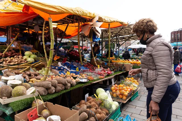 A woman in protective face mask is seen shopping by a stall at Lewisham street market as the second wave of Coronavirus hits London, England on October 6, 2020. (Photo by Dominika Zarzycka/NurPhoto via Getty Images)