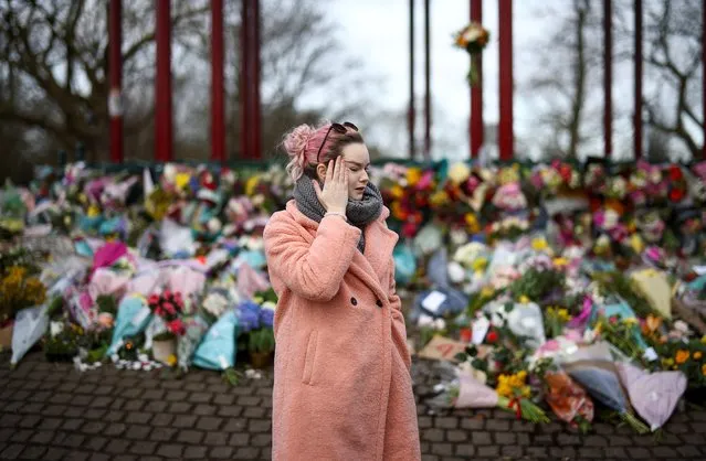 A woman reacts as she mourns at a memorial site at the Clapham Common Bandstand, following the kidnap and murder of Sarah Everard, in London, Britain on March 14, 2021. (Photo by Henry Nicholls/Reuters)