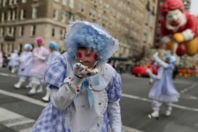 A clown blows confetti toward spectators during the Macy's Thanksgiving Day parade, Thursday, November 24, 2016, in New York. (Photo by Julie Jacobson/AP Photo)