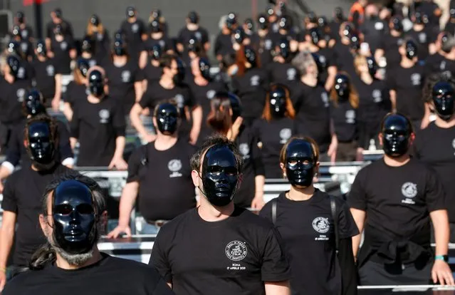 Theatre workers wear masks while standing next to boxes used backstage at entertainment venues, as they attend a demonstration calling on the government to let artists return to work amid the coronavirus disease (COVID-19) outbreak, at Piazza del Popolo, in Rome, Italy, April 17, 2021. (Photo by Remo Casilli/Reuters)