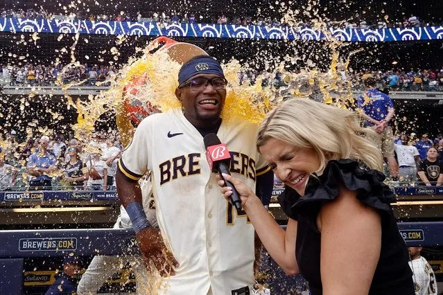 Milwaukee Brewers' Andruw Monasterio is douced by Willy Adames while being interviewed by Sophia Minnaert after the 10th inning of a baseball game against the Colorado Rockies Wednesday, August 9, 2023, in Milwaukee. The Brewers won 7-6. (Photo by Morry Gash/AP Photo)