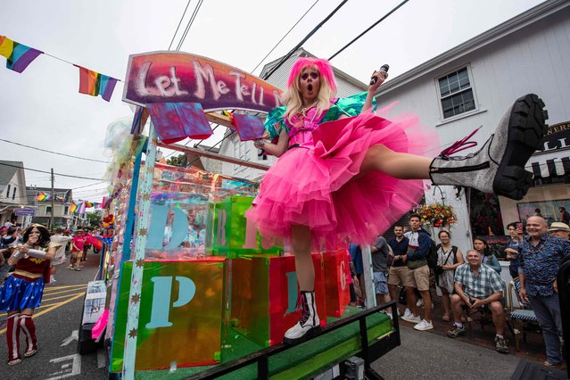 Parade revelers sing and dance from floats during the 45th Annual Provincetown Carnival Parade in Provincetown, Massachusetts, on August 17, 2023. The carnival, which celebrates community, expression and creativity was started in 1978 by the Provincetown Business Guild. The theme for the parade this year is “Land of Toys”. The Guild uses the parade to introduce new LGBTQ+ visitors and their allies to the Provincetown community. (Photo by Joseph Prezioso/AFP Photo)