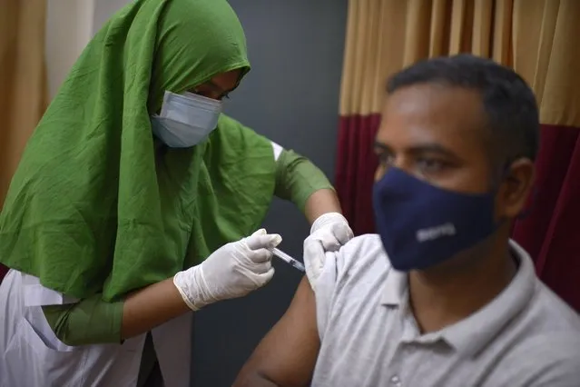 A Bangladeshi man receives a vaccine for COVID-19 at a hospital in Dhaka, Bangladesh, Saturday, May 8, 2021. India's surge in coronavirus cases is having a dangerous effect on neighboring Bangladesh. Health experts warn of imminent vaccine shortages just as the country should be stepping up its vaccination drive, and as more contagious virus variants are beginning to be detected. (Photo by Mahmud Hossain Opu/AP Photo)