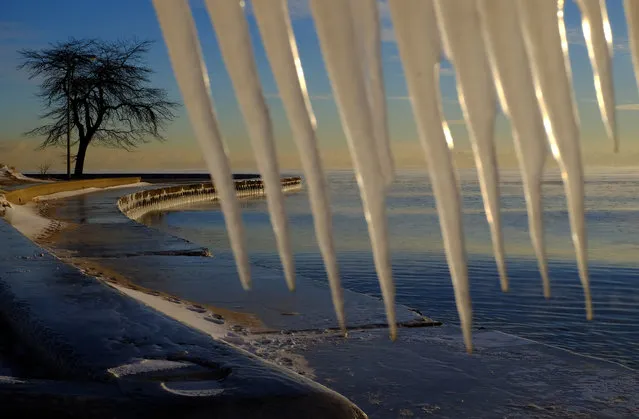 Icicles hang over a rail along the shore of Lake Michigan in Chicago on Wednesday, January 13, 2016 as bitter cold temperatures affected the area. (Photo by Kiichiro Sato/AP Photo)