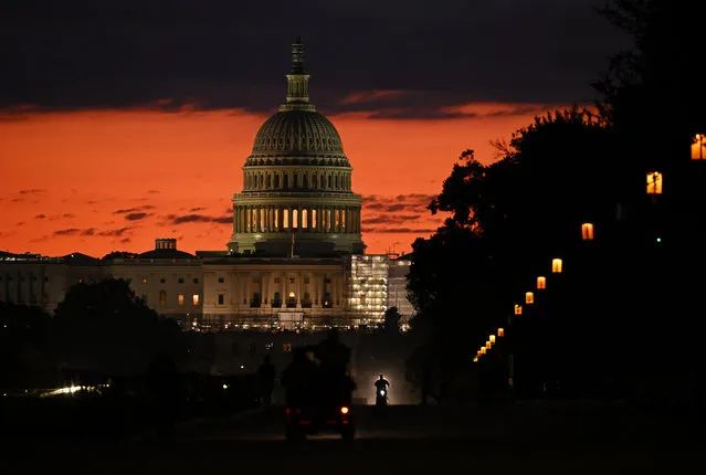 The sun rises behind the United States Capitol on Wednesday September 20, 2023 in Washington, DC. Lawmakers are negotiating in order to prevent a government shutdown. (Photo by Matt McClain/The Washington Post)