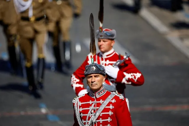 Bulgarian honour guard soldiers take part in the annual Bastille Day military parade on the Champs-Elysees avenue in Paris, France on July 14, 2022. Delegations from Estonia, Latvia, Lithuania, Poland, Czech Republic, Slovakia, Hungary, Romania and Bulgaria marched ahead of the traditional French military parade, each national carrying their respective national flag. The countries – all NATO members like France – have been in the international spotlight since Russia invaded Ukraine in February, with many of them sharing borders with Ukraine or Russia. (Photo by Sarah Meyssonnier/Reuters)
