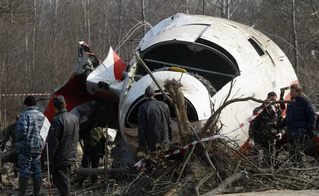 In this April 14, 2010 file photo emergency ministry workers preparing to load the wreckage of the Polish presidential plane on a  transporter just outside the Smolensk airport, western Russia, Poland's government has opened a new investigation into the 2010 plane crash in Russia that killed President Lech Kaczynski, the twin brother of the chairman of the country's ruling right-wing party. Defense Minister Antoni Macierewicz announced the new investigation Thursday February 4, 2016  in Warsaw, saying the original investigation by Polish authorities was riddled with “mistakes” and “abnormalities”. (Photo by Mikhail Metzel/AP Photo)