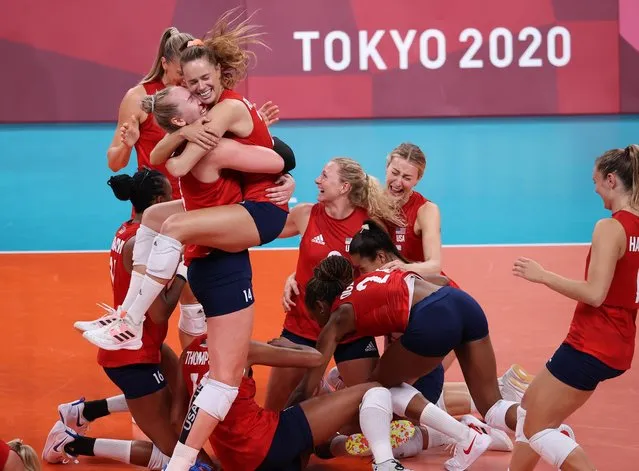 USA's Kelsey Robinson (R) hugs USA's Michelle Bartsch-Hackley as they celebrate their victory in the women's gold medal volleyball match between Brazil and USA during the Tokyo 2020 Olympic Games at Ariake Arena in Tokyo on August 8, 2021. (Photo by Ivan Alvarado/Reuters)