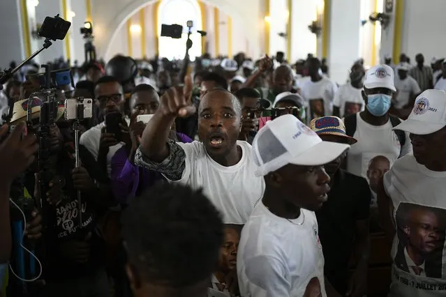A man yells for justice during a memorial service for assassinated Haitian President Jovenel Moïse in the Cathedral of Cap-Haitien, Haiti, Thursday, July 22, 2021. Moïse was killed in his home on July 7. (Photo by Matias Delacroix/AP Photo)