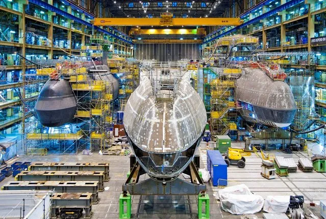 BAE Systems handout photo of The forward end of the fifth Astute class submarine, Anson, in the Devonshire Dock Hall to begin construction on December 19, 2013.  The 250-tonne section, standing at 38 feet tall and 34 feet wide, travelled through Barrow-in-Furness yesterday and now sits between her state-of-the-art sister submarines Audacious and Artful, ready for the next steps of the building process. (Photo by BAE Systems/PA Wire)