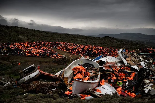 Wrecked boats and thousands of life jackets used by refugees and migrants during their journey across the Aegean sea lie in a dump in Mithimna on February 19, 2016. The EU and Turkey will hold a special summit in early March to push forward a deal to stem the migration crisis, European Council President Donald Tusk said. (Photo by Aris Messinis/AFP Photo)