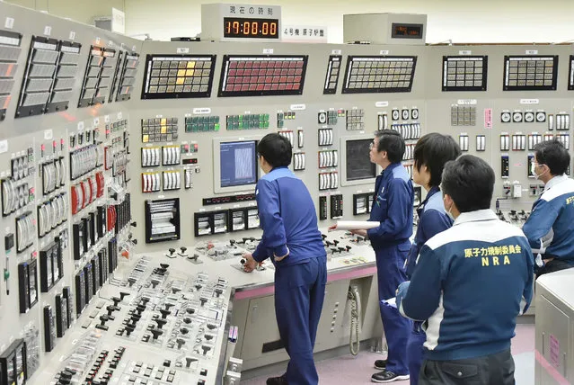 Employees of the Takahama nuclear power plant monitor instruments at its operation room in Takahama, Fukui prefecture, 380 kilometres (236 miles) west of Tokyo, on February 26, 2016. Osaka-based Kansai Electric Power resumed operations of the Number Four reactor of the plant, the fourth to come back online following a nationwide shutdown after the March 2011 tsunami disaster. (Photo by AFP Photo/JIJI Press)