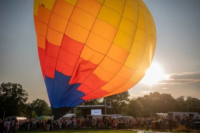 Balloons launch Sunday evening, August 20, 2023, from Simard- Payne Memorial Park in Lewiston, Maine, on the last day of the Great Falls Balloon Festival. (Photo by Andree Kehn/Sun Journal via AP Photo)