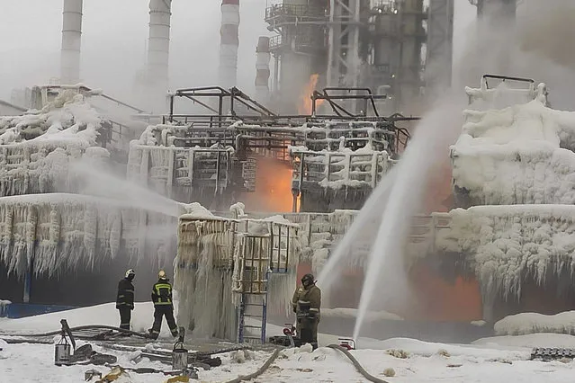In this photo released by Telegram Channel of head of the Kingisepp district administration Yuri Zapalatskiy, fire fighters extinguish the blaze at Russia's second-largest natural gas producer, Novatek in Ust-Luga, 165 kilometers southwest of St. Petersburg, Russia, Sunday, January 21, 2024. Fire broke out at a chemical transport terminal at Russia's Ust-Luga port Sunday following two explosions, regional officials reported. Local media reported that the port had been attacked by Ukrainian drones, causing a gas tank to explode. (Photo by Telegram Channel of head of the Kingisepp district administration Yuri Zapalatskiy via AP Photo)