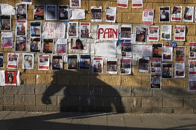 Photos of Israelis missing and held captive in Gaza, are displayed on a wall in Tel Aviv, Israel, Wednesday, October 18, 2023. The Israeli army says some 200 people were kidnapped and taken to Gaza in Hamas' cross-border attack on Israel on Oct. 7. (Photo by Ohad Zwigenberg/AP Photo)