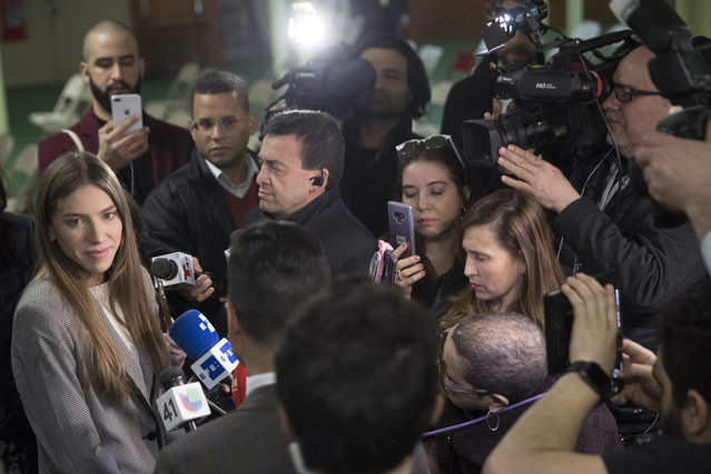 Fabiana Rosales, left, wife of Venezuelan opposition leader Juan Guaido, speaks to reporters before attending Mass at St. Teresa's Church on the Lower East Side of Manhattan, Tuesday, March 26, 2019, in New York. Rosales is emerging as a prominent figure in Guaido's campaign to bring change in the crisis-wracked country. (Photo by Mary Altaffer/AP Photo)