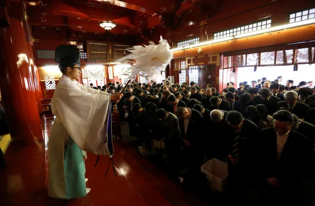 People bow during a purification ceremony as they offer prayers at the start of the new business year at Kanda Myojin Shrine, which is known to be frequented by worshippers seeking good luck and prosperous businesses, in Tokyo, Japan, January 4, 2017. (Photo by Toru Hanai/Reuters)