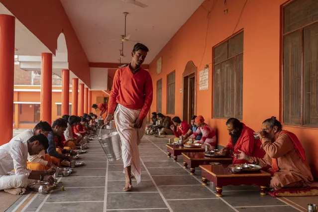 In this Wednesday, December 12, 2018 photo, Hindu students of the Baghambari Math Gaddi have lunch in Prayagraj, India. As with similar movements across the world, Hindu nationalism, once fringe, has now taken a central place in India’s politics. (Photo by Bernat Armangue/AP Photo)