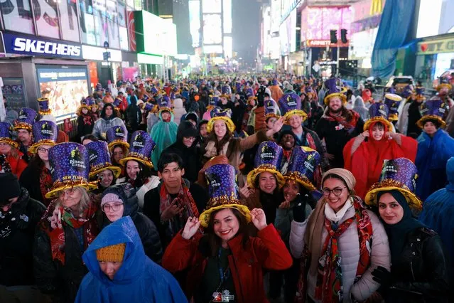 People gather in Times Square in the first New Year's Eve event without restrictions since the coronavirus disease (COVID-19) pandemic in the Manhattan borough of New York City, New York, U.S., December 31, 2022. (Photo by Andrew Kelly/Reuters)