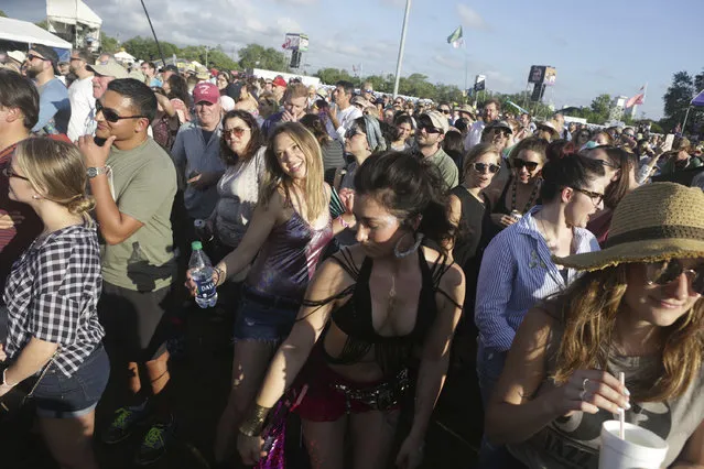 Samantha Gaboula of San Francisco, left, and Kelly Grace, of Philadelphia, dance to the music of Alanis Morissette at the Gentilly Stage at the New Orleans Jazz & Heritage Festival in New Orleans, Thursday, April 25, 2019. (Photo by Doug Parker/AP Photo}