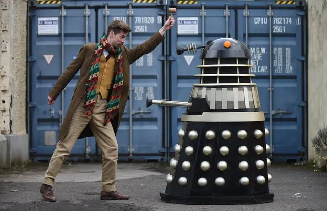 Tommy Alexander of Great Western Auctions faces off against a full-size replica Dalek from Doctor Who on March 20, 2024, estimated to sell for between £500 and £800 on Friday when it goes under the hammer in a fine art and antiques sale. (Photo by James Chapelard/The Times)