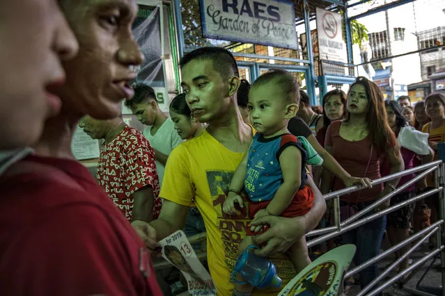 Filipinos enter a polling precinct to cast their votes on May 13, 2019 in Manila, Philippines. About 60 millions of Filipino voters will head to the polls on May 13 for the congressional midterm elections and bring a set of winners and losers for lawmakers and local government officials in the Philippines. Based on reports, Mondays midterm elections will be a test on Filipino President Rodrigo Dutertes popularity as recent polls show that his administration remains popular ahead of the midterm elections despite receiving largely negative attention overseas. (Photo by Ezra Acayan/Getty Images)