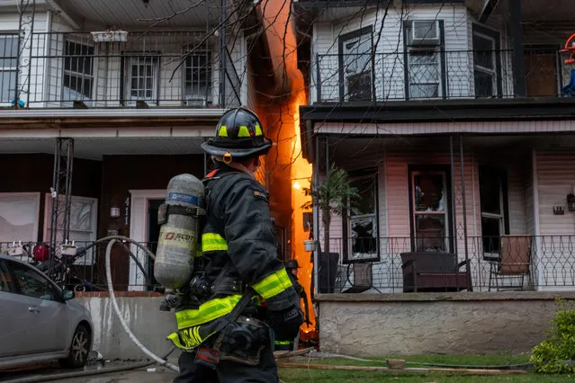 Firefighters try to contain a four alarm fire in two homes in Brooklyn on March 22, 2024 in New York City. The fast moving fire began in the late afternoon in a neighborhood with a large Orthodox Jewish and Southeast Asian population and took dozens of firefighters to contain. (Photo by Spencer Platt/Getty Images)