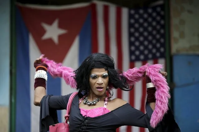 Sarah Maria, 50, a transvestite, poses for a photograph in front of the Cuban and U.S. flags in Havana, March 23, 2016. Regarding Obama's historic visit to the island, Maria said “I believe this could be very important for my country”. (Photo by Ueslei Marcelino/Reuters)