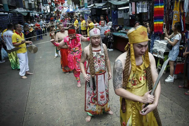 Chinese devotees with their cheeks pierced with skewers take part in a procession during the Guan Ping Festival in Chinatown in Kuala Lumpur, Saturday, June 15, 2019. The festival is held in celebration of the birthday of Chinese deity Guan Ping is believed to bring prosperity for local businesses. (Photo by F.L. Wong/AP Photo)