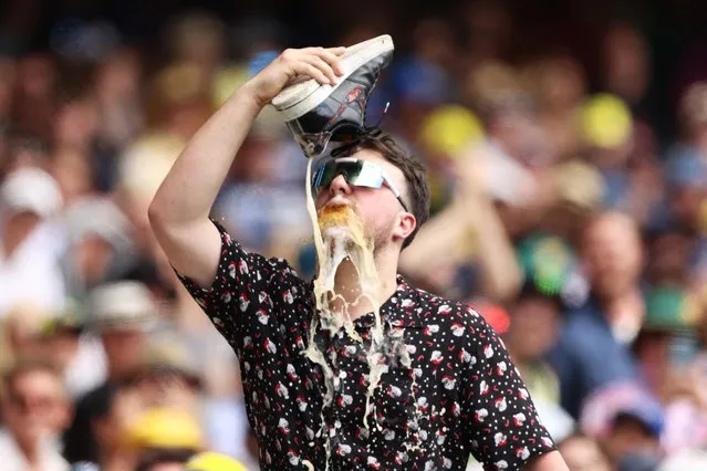 A cricket fan does a shoey during day two of the Third Test match in the Ashes series between Australia and England at Melbourne Cricket Ground on December 27, 2021 in Melbourne, Australia. (Photo by Robert Cianflone/Getty Images)