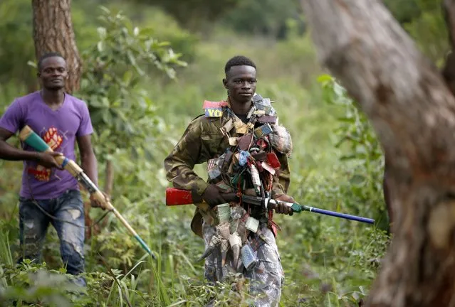 Members of the anti-balaka, a Christian militia, patrol outside the village of Zawa April 8, 2014. (Photo by Goran Tomasevic/Reuters)