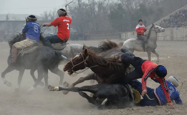 Kyrgyz riders play the traditional Central Asian sport of Kok-Boru (Gray Wolf) or Buzkashi (Goat Grabbing) during celebrations for Nowruz in Bishkek on March 16, 2017. Mounted players compete for points by throwing a stuffed sheepskin into a well. Nowruz, “The New Year” in Farsi, is an ancient festival marking the first day of spring in Central Asia. (Photo by Vyacheslav Oseledko/AFP Photo)