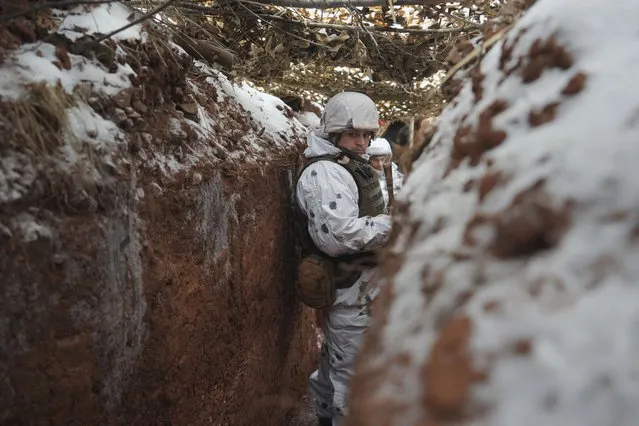 Ukrainian servicemen stand in a trench at a frontline position in the Donetsk region, eastern Ukraine, Monday, January 31, 2022. (Photo by Vadim Ghirda/AP Photo)