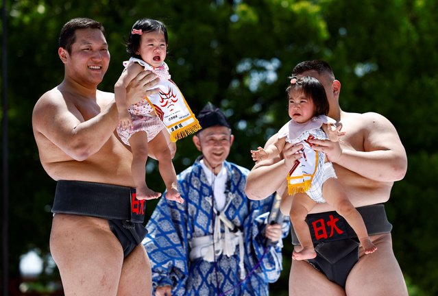 Babies cry as they are held up by amateur sumo wrestlers during “Nakizumo” or a baby-crying sumo contest at Sensoji temple in Tokyo, Japan, on April 28, 2024. (Photo by Issei Kato/Reuters)