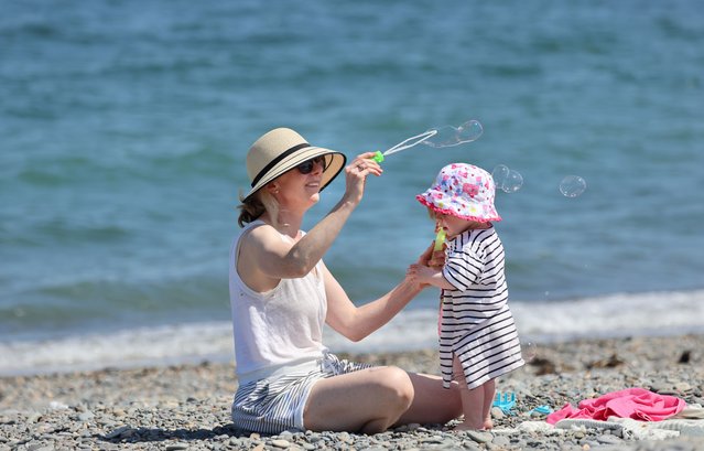 Cliona Cicek and her daughter Arabella, (1) from Bray enjoy the bank holiday sunshine in Bray, Co. Wicklow, Ireland on June 5, 2023. (Photo by Dara Mac Dónaill/The Irish Times)