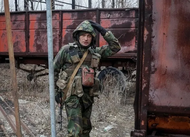 A Ukrainian service member stands on the front line near the city of Novoluhanske in the Donetsk region, Ukraine on February 22, 2022. (Photo by Gleb Garanich/Reuters)